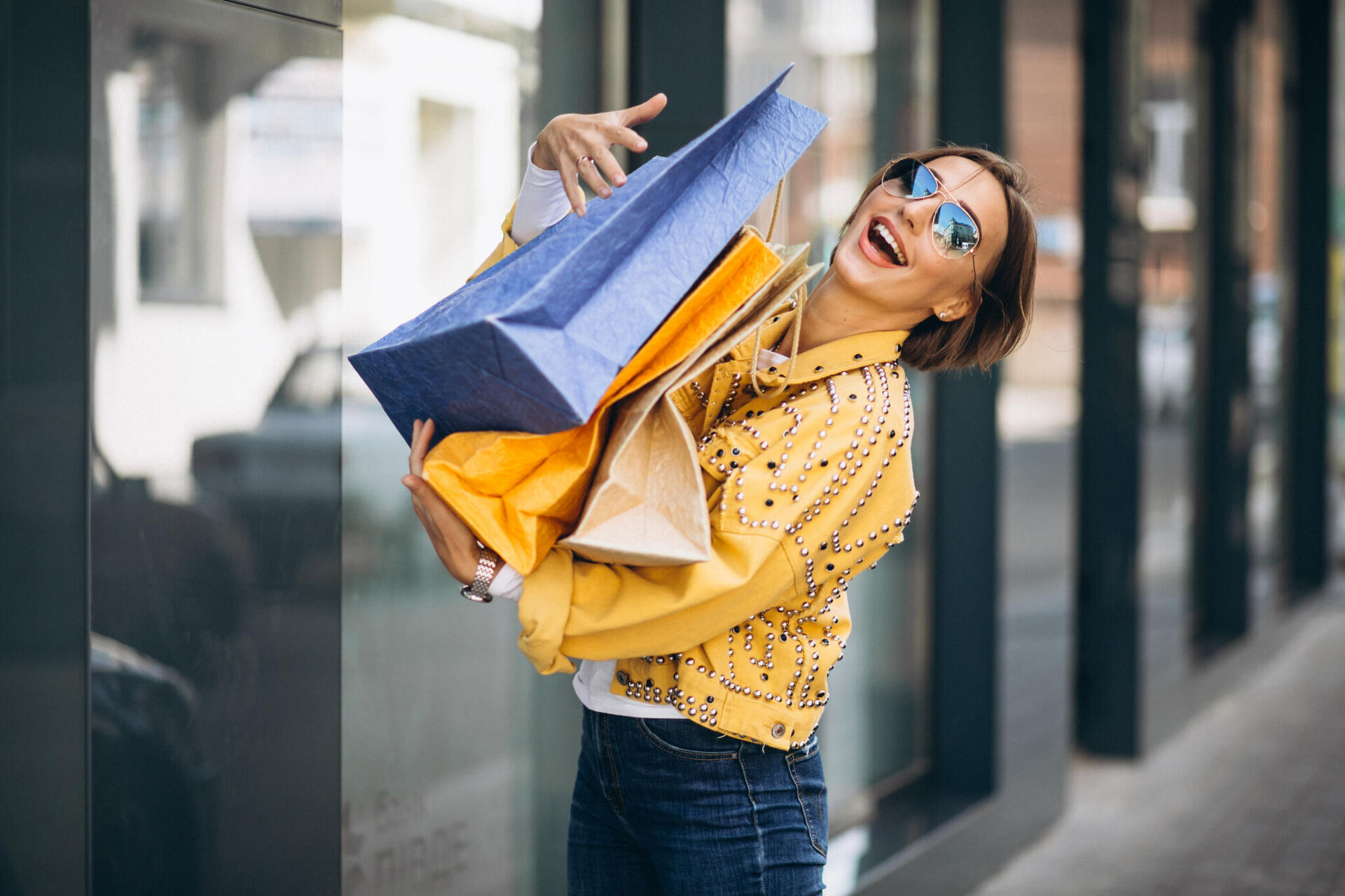 young-woman-with-shopping-bags-city