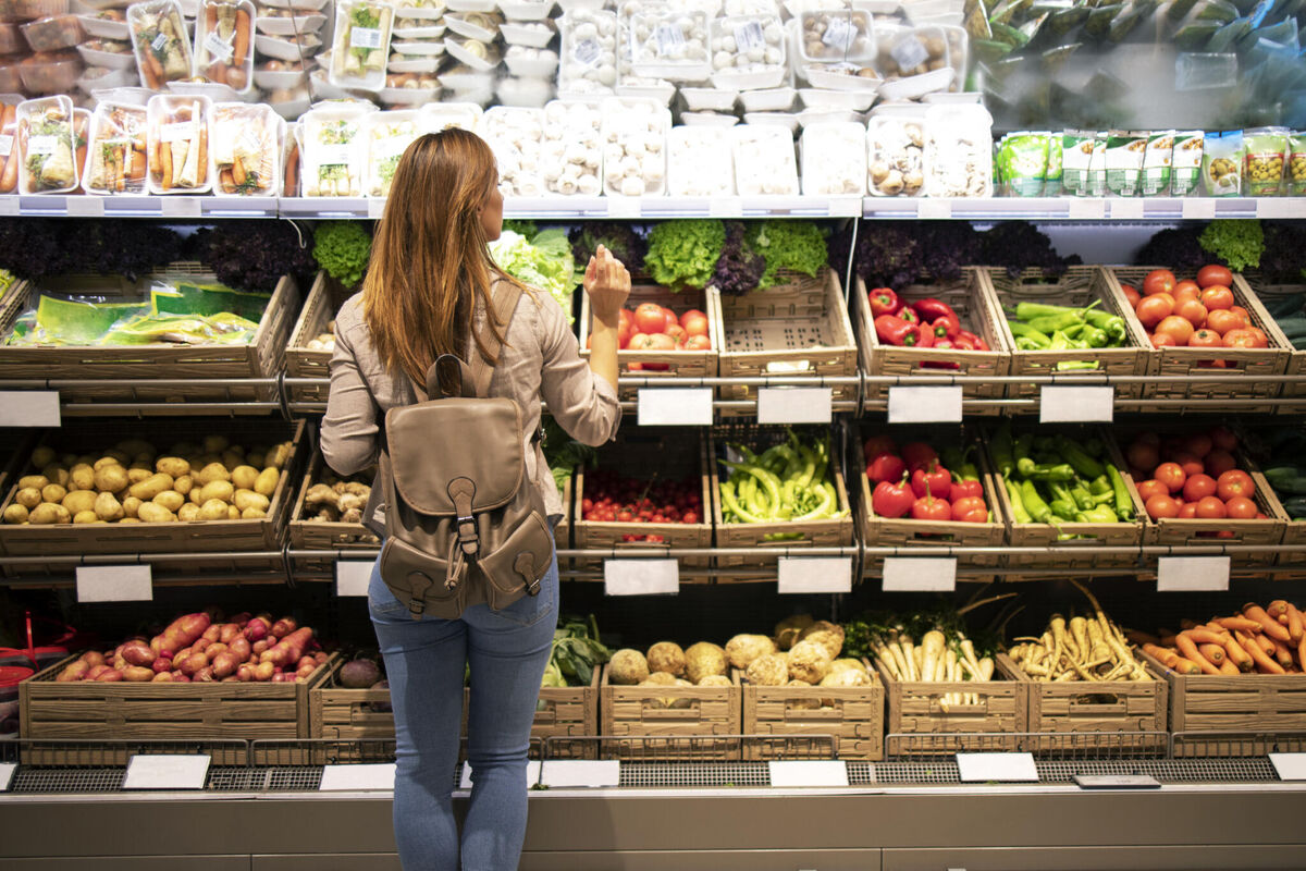 good-looking-woman-standing-front-vegetable-shelves-choosing-what-buy