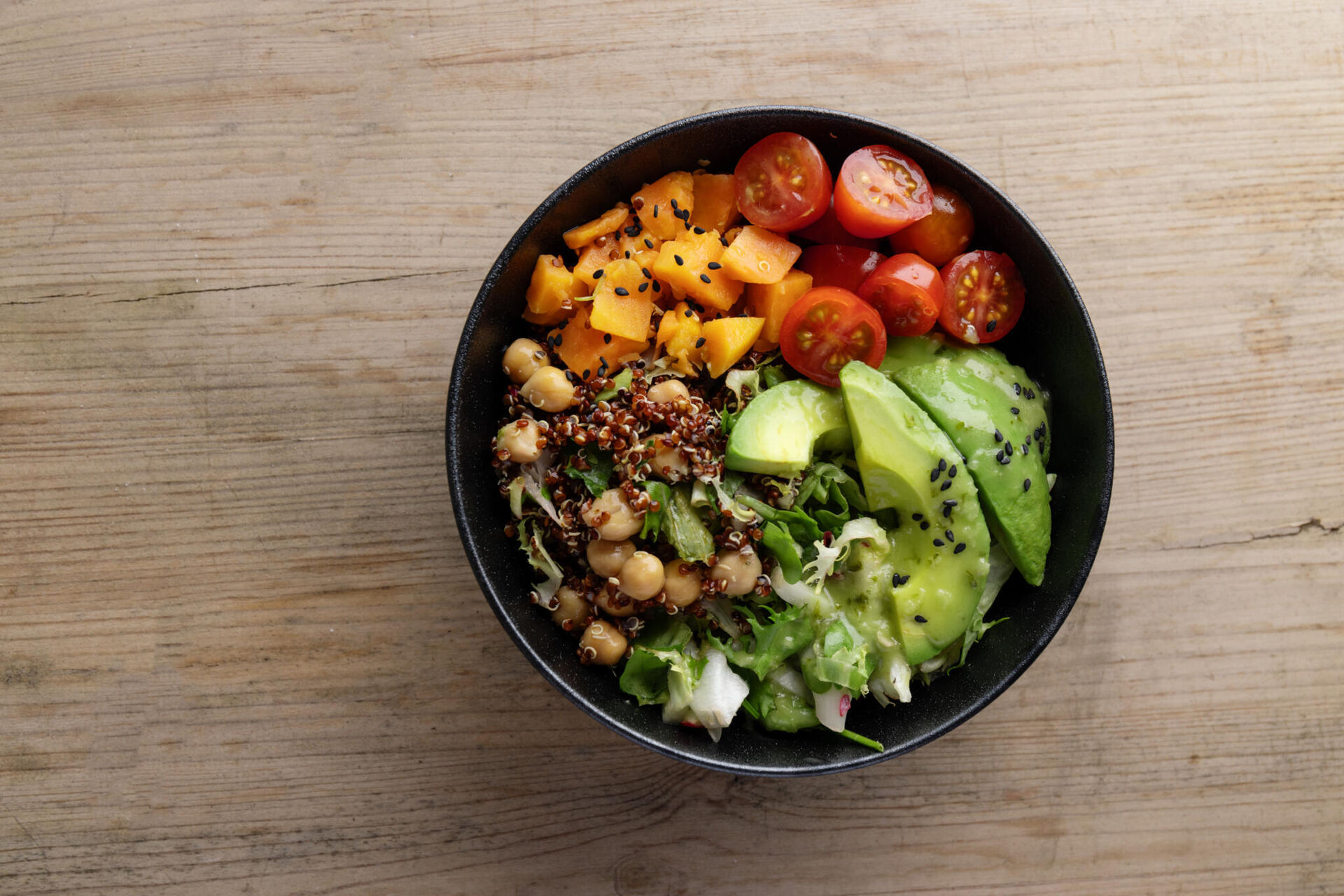 tasty-fresh-poke-bowl-with-avocado-quinoa-vegetables-top-view