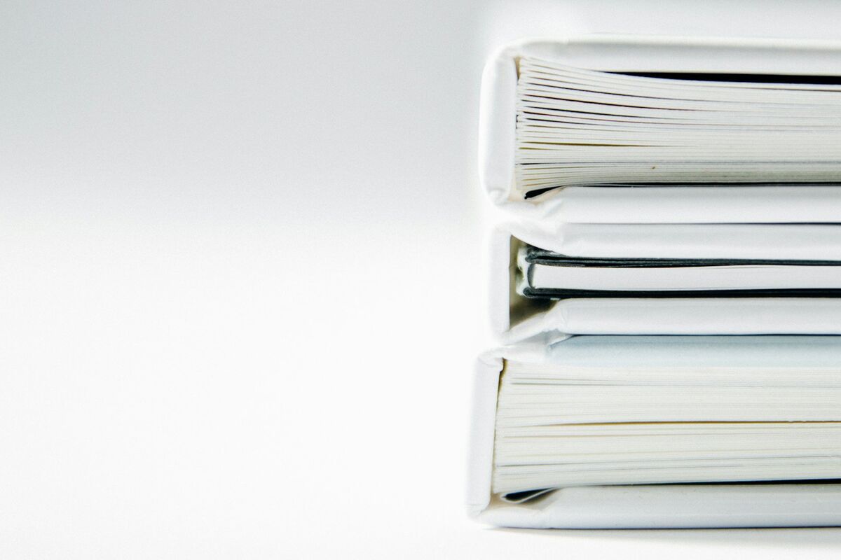 A stack of thick folders on a white surface xn4t2pvuugk 425cdc49cbe25574c5f5de965a66b934 2000