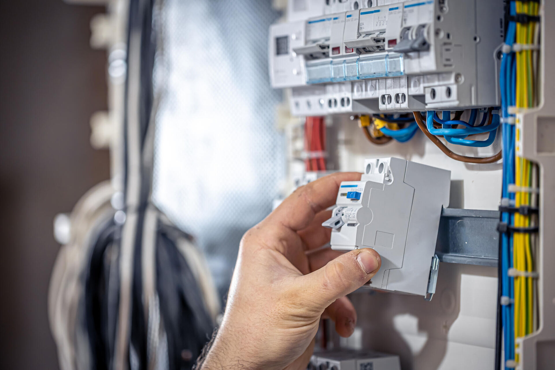 sfeerbeeld electriciteit male-electrician-works-switchboard-with-electrical-connecting-cable