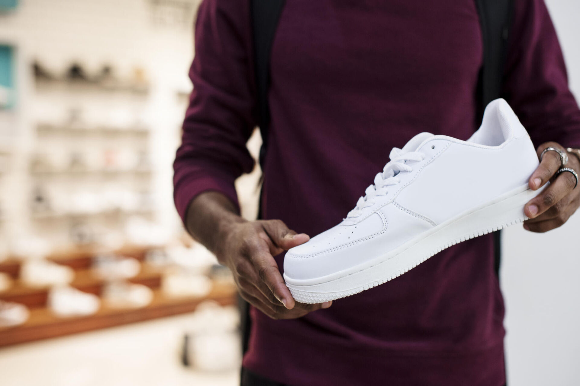 african-man-holding-white-sneaker