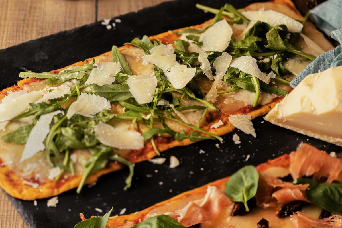 vertical-shot-delicious-bread-filled-with-bacon-vegetables-cheese-wooden-table